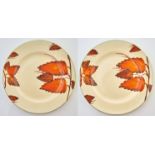 CLARICE CLIFF. A PAIR OF A J WILKINSON CHESTNUT LEAVES PLATES, C1930, 25.5CM DIAM, PRINTED