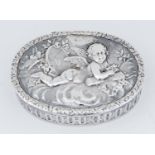 A GERMAN SILVER TRINKET BOX, THE LID DIE STAMPED WITH PUTTO ON A CLOUD, THE SIDES WITH GUILLOCHE,