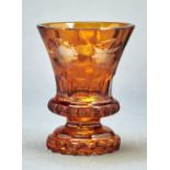 A BOHEMIAN FACETED AND AMBER FLASHED GLASS BEAKER, MID 19TH C, THE FLARED BOWL ENGRAVED WITH FIVE