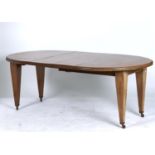 AN OVAL MAHOGANY EXTENDING DINING TABLE, C1905, THE TOP WITH MOULDED LIP ABOVE BOLD SQUARE TAPERED