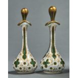 A PAIR OF CASED GLASS SCENT BOTTLES AND STOPPERS, MID 19TH C, OF GREEN GLASS CASED IN WHITE,