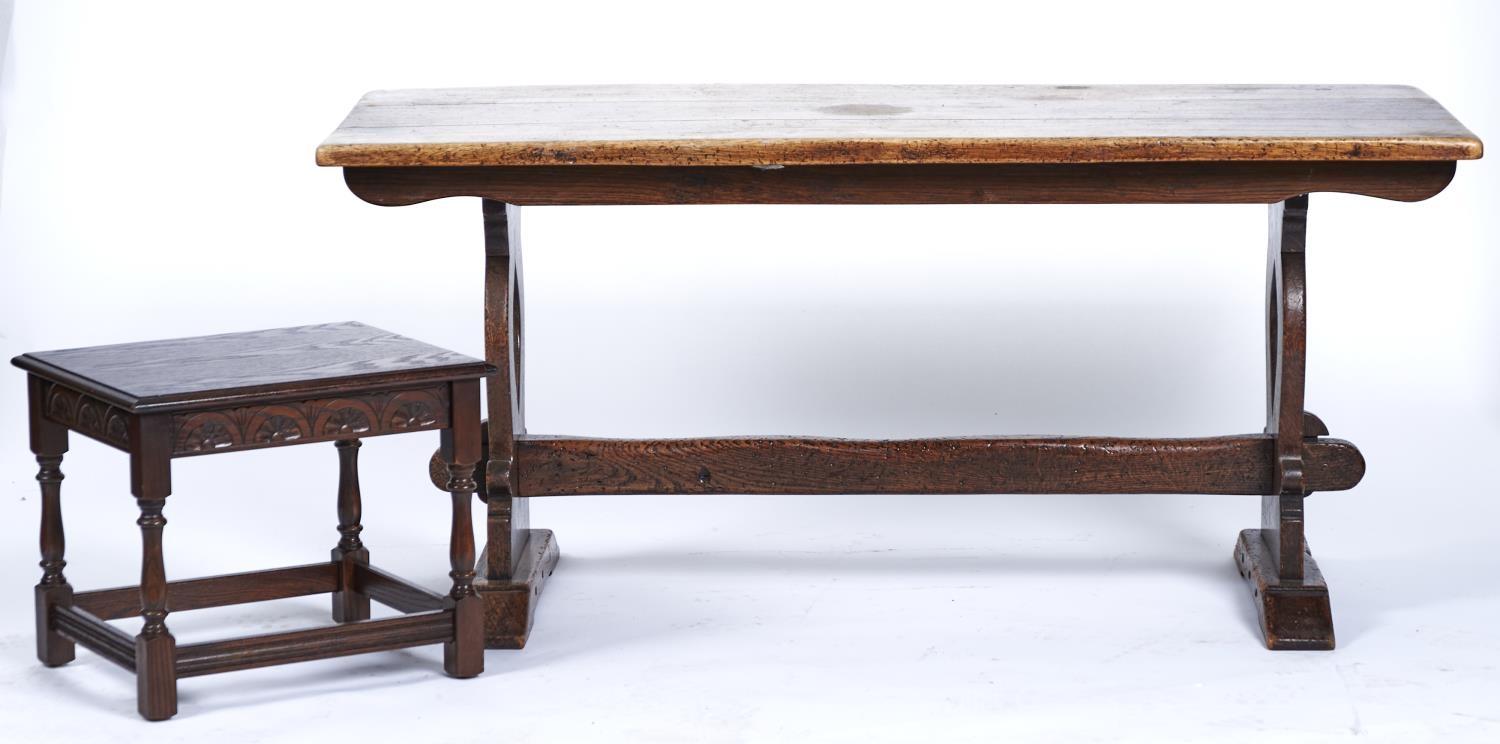 A REPRODUCTION OAK REFECTORY TABLE, THIRD QUARTER 20TH C, THE RECTANGULAR TOP ABOVE A PAIR OF