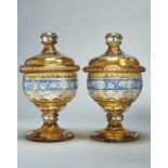 A PAIR OF BOHEMIAN CUT AND BLUE AND AMBER FLASHED GLASS SWEETMEAT JARS AND COVERS, EARLY 20TH C, THE