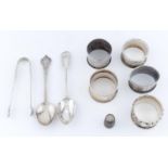 FIVE EDWARDIAN AND LATER SILVER NAPKIN RINGS, A BRITANNIA STANDARD REPLICA LACE BACK SPOON, A