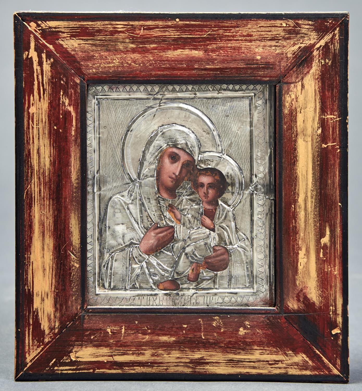 A RUSSIAN ICON OF MARY AND THE CHRIST CHILD IN SILVER FRAME, ENGRAVED AND WRIGGLEWORK DECORATED