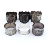 A SET OF THREE VICTORIAN SILVER NAPKIN RINGS, DIE STAMPED WITH ARMORIALS, BY MAPPIN & WEBB,