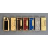 ALFRED DUNHILL. A UNIQUE CIGARETTE LIGHTER AND SIX ROLLAGAS LIGHTERS, INCLUDING ONE GEMLINE LIGHTER,