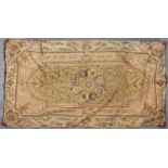 A CREWEL WORK PANEL OR RUG, DECORATED TO THE CENTRE WITH A FLORAL ROUNDEL WITHIN ARCHED FRAME, THE