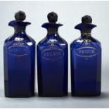 THREE REGENCY SQUARE SECTION COBALT BLUE AND GILT GLASS DECANTERS AND STOPPERS, EARLY 19TH C,