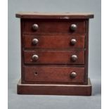 A VICTORIAN MAHOGANY MINIATURE CHEST OF DRAWERS, WITH  GRADUATED DRAWERS, ON  SKIRTED PLINTH, 20CM