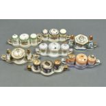 SEVEN NORITAKE CONDIMENT SETS, EARLY 20TH C, EACH ON TWO HANDLED TRAY, ONE WITH IRIDESCENT GLAZE,