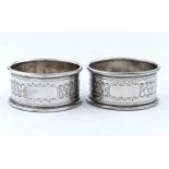 A PAIR OF EDWARDIAN SILVER NAPKIN RINGS, ENGRAVED WITH BAND OF FOLIAGE, BY WILLIAM NEALE & SONS,
