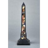 A VICTORIAN ASHFORD BLACK MARBLE AND COLOURED HARDSTONE OBELISK, LATE 19TH C, ON STEPPED SQUARE