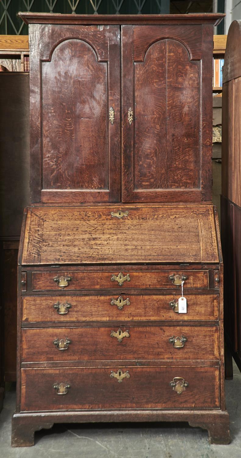 AN OAK BUREAU BOOKCASE, LATE 18TH C, THE TOP WITH FLARED CAVETTO MOULDED CORNICE ABOVE A PAIR OF