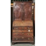 AN OAK BUREAU BOOKCASE, LATE 18TH C, THE TOP WITH FLARED CAVETTO MOULDED CORNICE ABOVE A PAIR OF