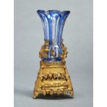 A FRENCH BLUE CASED GLASS VASE WITH EMBOSSED GILTMETAL FOOT, C1870, THE VASE HELD IN POSITION BY