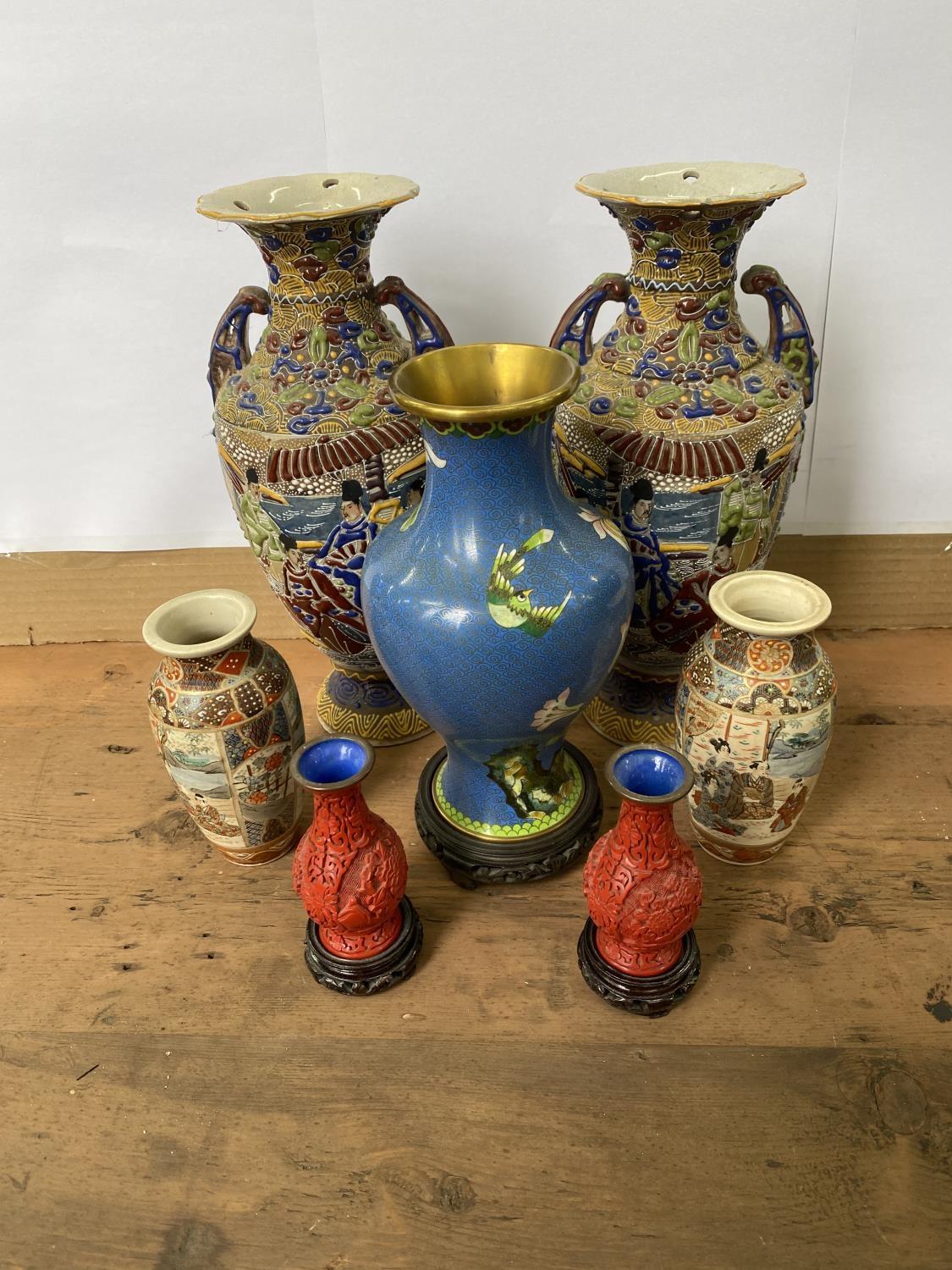 A PAIR OF SATSUMA VASES, ENAMELLED WITH FIGURES IN RESERVES, TWO HANDLED, WITH WAISTED NECKS AND