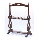 A VICTORIAN WALNUT WHIP AND BOOT RACK, C1840, THE ARCHED TOP RAIL WITH KIDNEY SHAPED CARRYING HANDLE