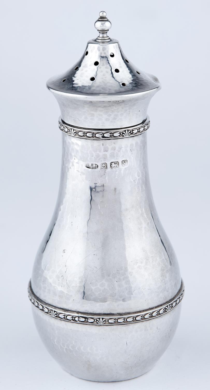 A EDWARD JONES. AN ARTS AND CRAFTS SILVER SUGAR CASTER AND COVER, BALUSTER, APPLIED WITH TWO HUSKS