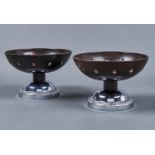 A PAIR OF BAKELITE PEDESTAL BOWLS, C1930'S, THE CIRCULAR PIERCED RED / BLACK BOWLS BEARING