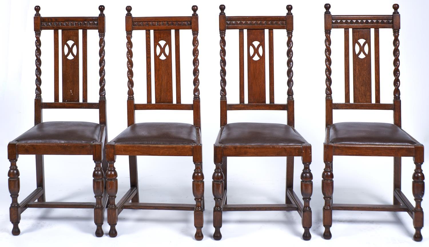 A SET OF FOUR OAK DINING CHAIRS, C1920, THE GEOMETRIC CARVED TOP RAILS WITH BALL FINIALS ABOVE