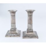 A PAIR OF VICTORIAN SILVER DWARF COLUMNAR SILVER CANDLESTICKS, THE BEADED SQUARE CAVETTO FOOT