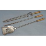 A set of three Victorian burnished steel fire irons, spiral design with ornate cast brass handle,