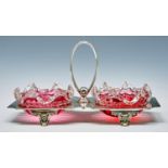 A Victorian EPNS stand and pair of cranberry glass dishes, with central oval handle, 28cm l Dishes