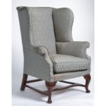 A mahogany stained wing back armchair in George III style, mid 20th c, the rectangular back,