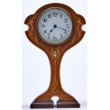 An Art Nouveau inlaid mahogany mantel clock, early 20th c, with shaped top and deeply waisted, on