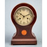 An Edwardian inlaid mahogany balloon shaped mantel clock, the cream enamel dial with Arabic