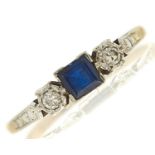 A sapphire and diamond ring, the step cut sapphire approximately 4 x 4mm, flanked by illusion set