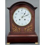 An Edwardian break arched mahogany clock, Winsor Bishop Norwich, with enamel dial, French gong