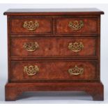 A reproduction burr elm veneered small chest of drawers, boxwood strung, the top with re-entrant