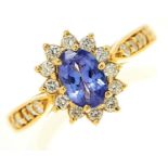 A tanzanite and diamond cluster ring, the tanzanite approximately 5 x 7mm, with diamond set