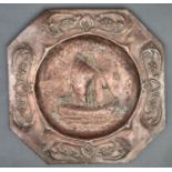 An Arts and Crafts copper repousse plaque, c1910, decorated to the centre with a ship and two birds,