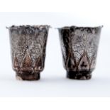 A pair of Chinese miniature silver beakers of lobed and leaf chased form, on ring foot, 47mm h, by