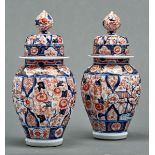 A pair of Japanese Imari jars and covers, Meiji period, of reeded oviform shape, 30cm h Small chip