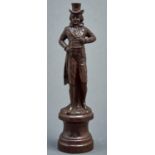 A carved and stained wood statuette of a dandy, late 19th c, on turned socle, 48cm h Small chip on