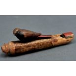 A polychrome soft wood bird shaped whistle, probably first half 20th c, 15cm l Single small worm