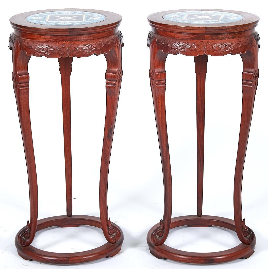 A pair of Chinese cloisonné enamel and carved hardwood stands, 20th c, in Qing style, on ring