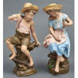 A pair of Goldscheider cold painted terracotta figures of a barefoot boy and girl, 1897-1914, seated