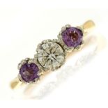 An amethyst and diamond three stone ring with round brilliant cut diamond, gold hoop marked 18ct