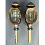 A pair of Victorian black japanned and brass carriage lamps, mid 19th c, the front cowl with