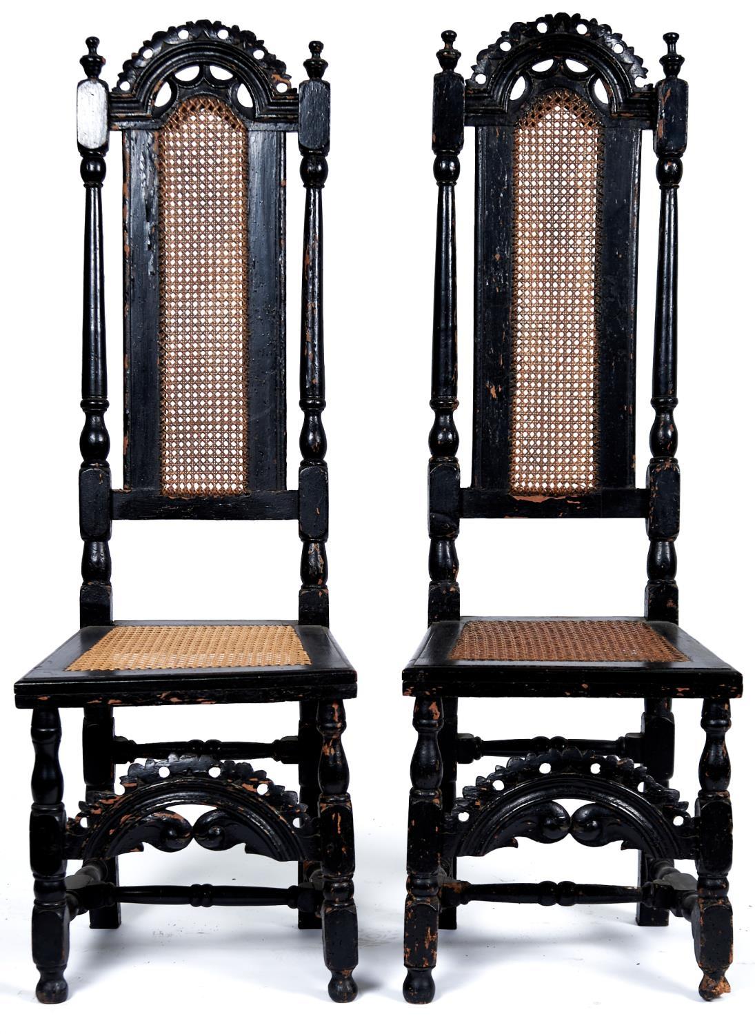 A pair of Queen Anne walnut high back caned chairs, c1700, with pierced arched cresting rails