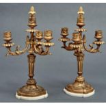 A pair of French ormolu candelabra, early 20th c, in Louis XVI style, of four lights on leafy
