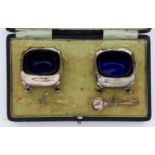 A pair of George V shaped square silver salt cellars, blue glass liners, 45 x 45mm, by Walker &