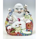 A Chinese famille rose figure of Budai, 20th c, with colourful yellow, blue and red robes with lotus