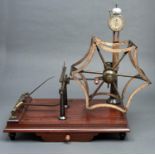 A Victorian brass and steel yarn tester, Goodbrand, late 19th c, with wooden handle, on mahogany