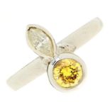 A diamond and yellow diamond ring, rub-over set in white gold marked 18ct, 5g, size M Diamond